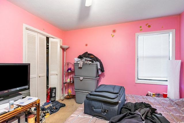 carpeted bedroom with a closet and ceiling fan