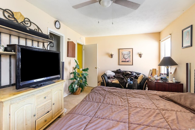 bedroom featuring ceiling fan and light carpet