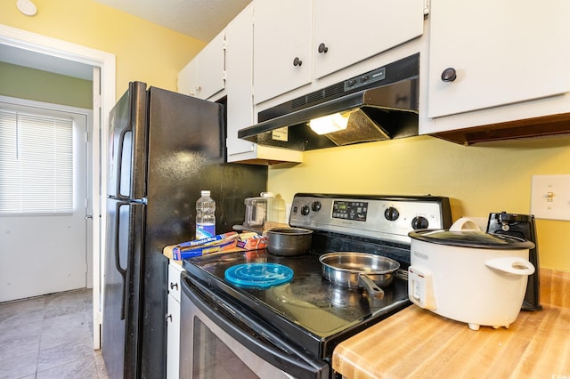 kitchen featuring white cabinets and stainless steel range with electric stovetop