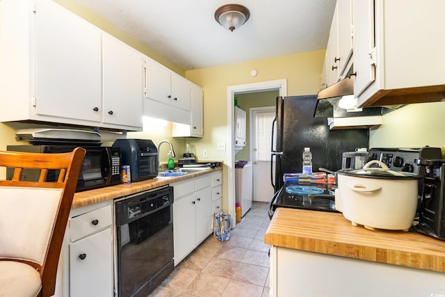 kitchen with black appliances, light tile patterned floors, decorative backsplash, white cabinets, and sink