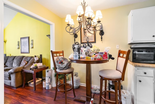 dining room with an inviting chandelier and dark hardwood / wood-style floors