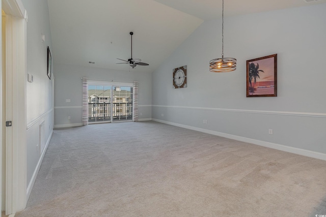 carpeted spare room featuring ceiling fan and high vaulted ceiling