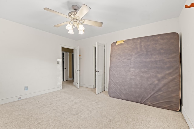 carpeted empty room with ceiling fan