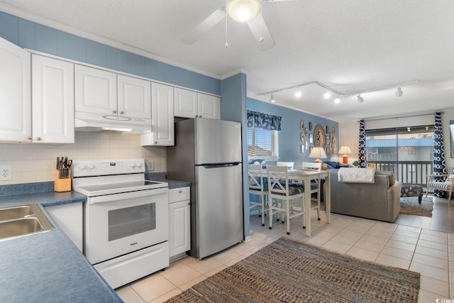 kitchen featuring light tile patterned floors, white cabinetry, electric stove, stainless steel refrigerator, and crown molding