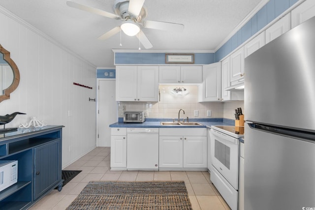 kitchen featuring white appliances, white cabinets, sink, light tile patterned floors, and crown molding