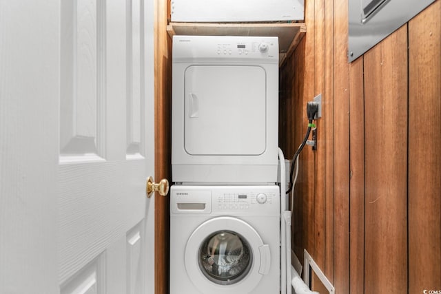 laundry room with stacked washing maching and dryer