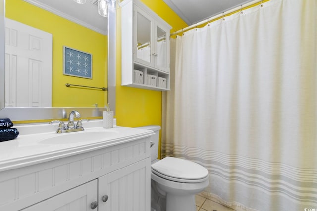 bathroom with toilet, vanity, ornamental molding, and tile patterned flooring