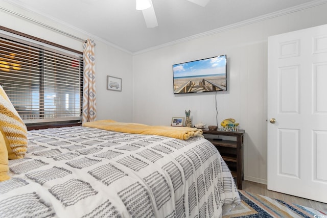 bedroom with ceiling fan, wood-type flooring, and ornamental molding