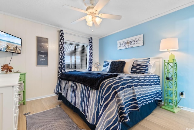 bedroom featuring ceiling fan, hardwood / wood-style floors, and ornamental molding