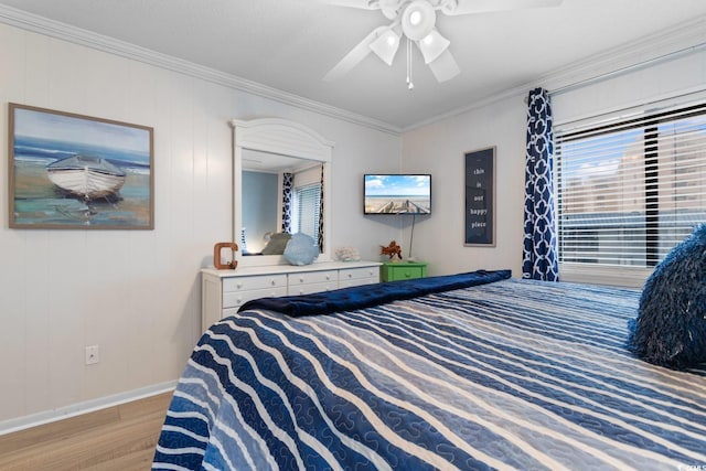 bedroom featuring ceiling fan, ornamental molding, and light hardwood / wood-style flooring