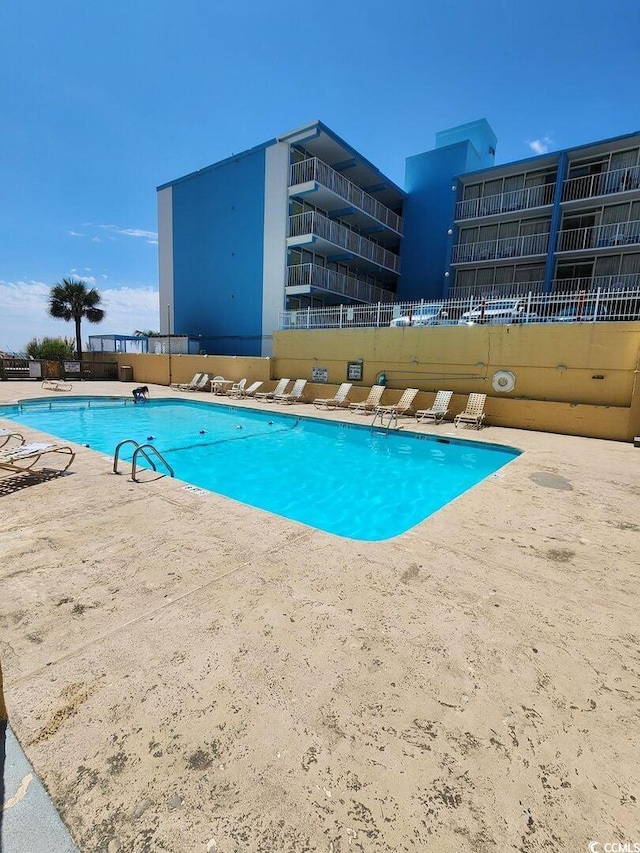 view of pool featuring a patio