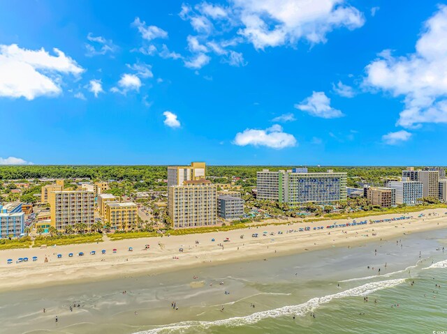 drone / aerial view featuring a water view and a view of the beach