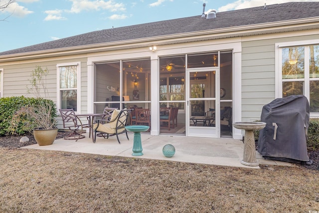 rear view of property featuring a sunroom and a patio