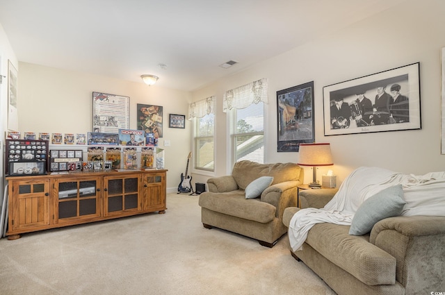 living area featuring light carpet