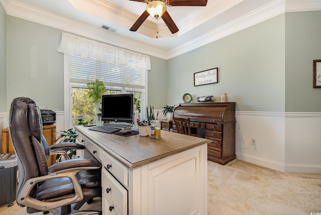 home office with light carpet, ceiling fan, crown molding, and a tray ceiling