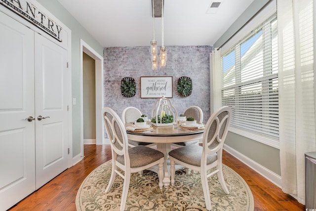 dining space with hardwood / wood-style floors