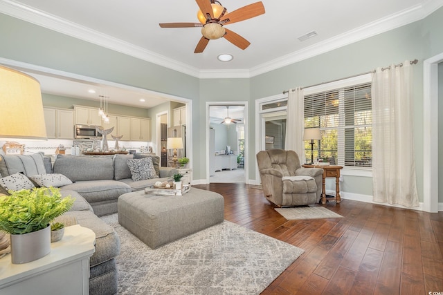 living room with ceiling fan, dark wood-type flooring, and ornamental molding