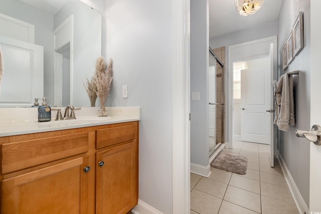 bathroom featuring an enclosed shower, vanity, and tile patterned flooring