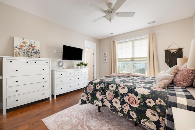 bedroom with ceiling fan and dark hardwood / wood-style flooring