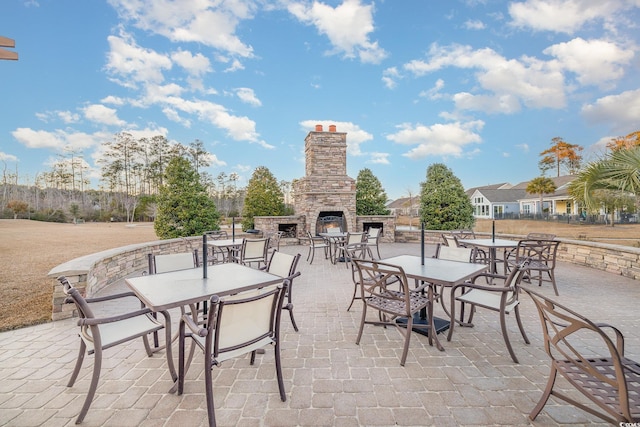 view of patio featuring an outdoor stone fireplace