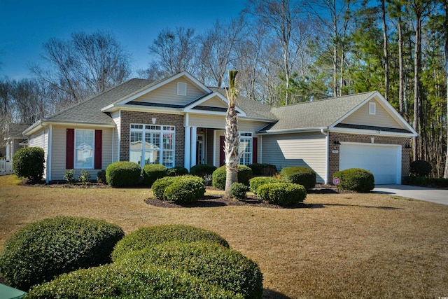 ranch-style home featuring a garage and a front yard