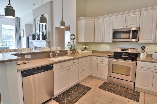 kitchen with white cabinetry, sink, pendant lighting, and appliances with stainless steel finishes