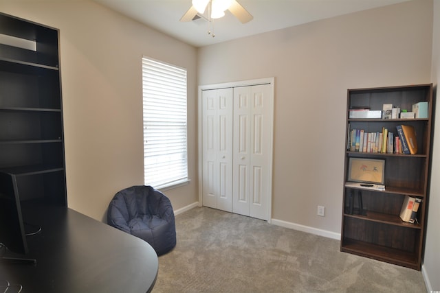 office featuring ceiling fan and light carpet