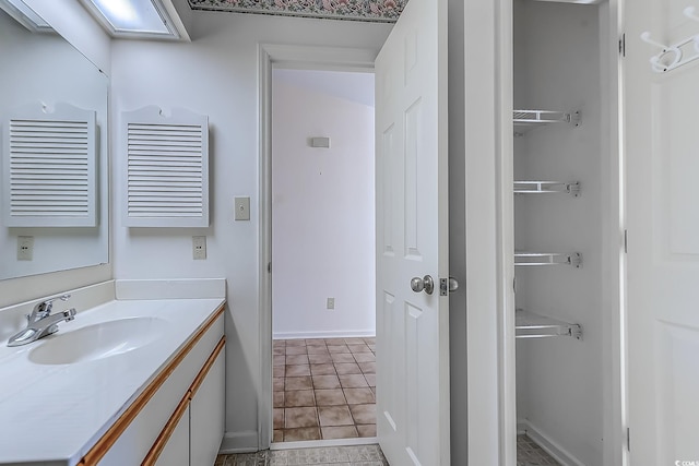 bathroom with tile patterned flooring and vanity