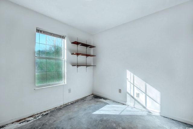 spare room with concrete flooring