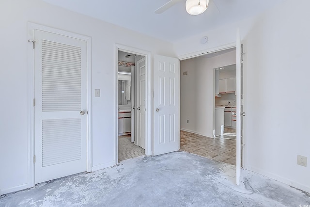 unfurnished bedroom with ceiling fan and concrete floors