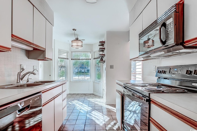 kitchen with black appliances, white cabinetry, light tile patterned floors, and sink