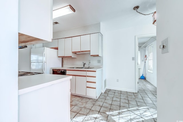 kitchen with sink, white refrigerator, white cabinets, and dishwasher