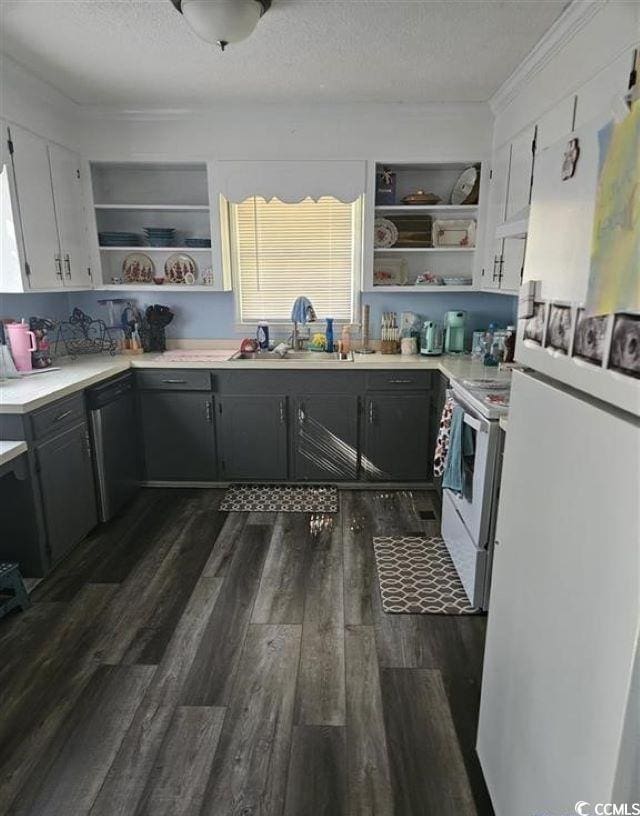 kitchen with a textured ceiling, white appliances, a sink, dark wood-style floors, and open shelves