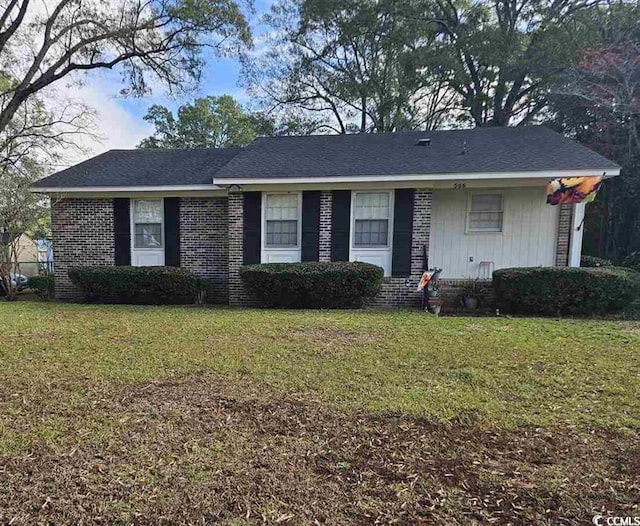 single story home featuring brick siding and a front yard