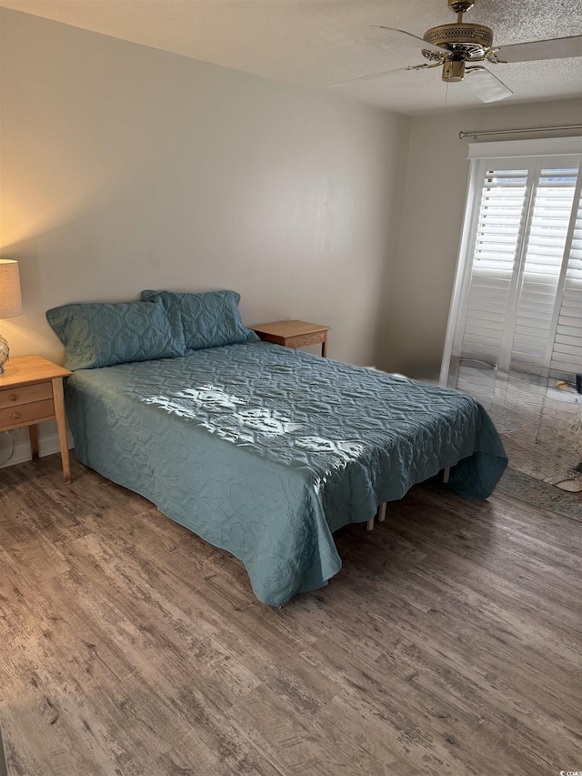 bedroom with hardwood / wood-style flooring and ceiling fan