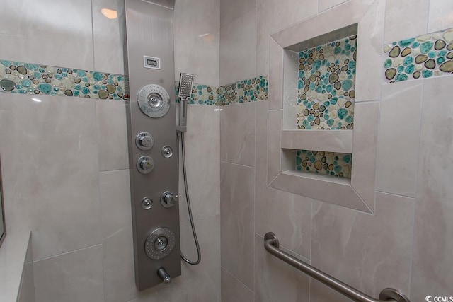 bathroom with a tile shower