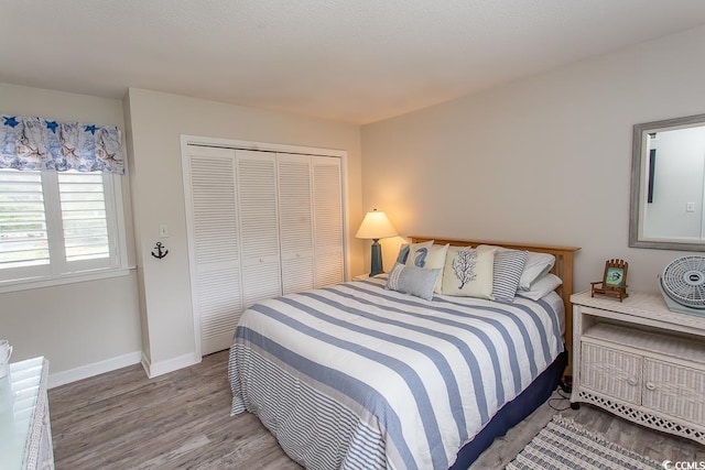 bedroom with a closet and light hardwood / wood-style flooring