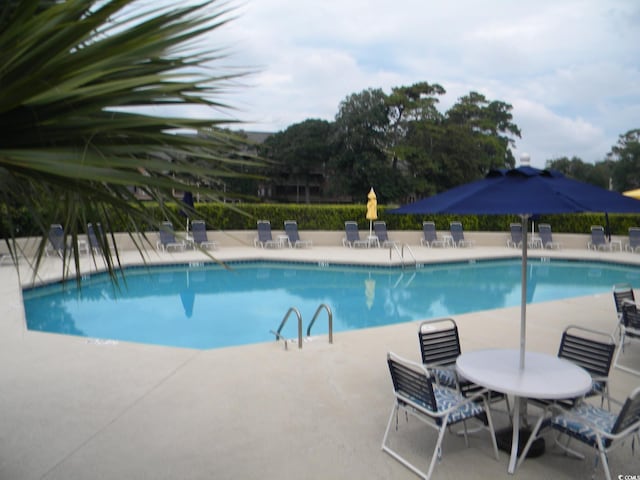 view of swimming pool featuring a patio area