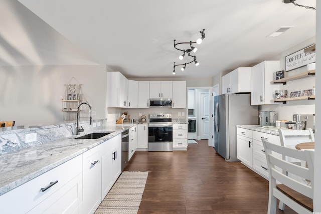 kitchen featuring light stone countertops, sink, white cabinets, and stainless steel appliances