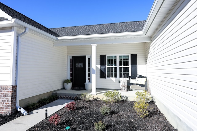 view of exterior entry with covered porch