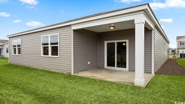 rear view of house with a yard and a patio