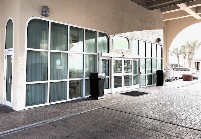 entrance to property featuring stucco siding