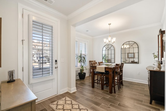 dining area featuring ornamental molding and a chandelier