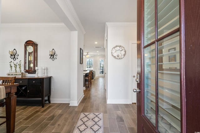 entryway featuring ceiling fan, ornamental molding, and dark hardwood / wood-style flooring