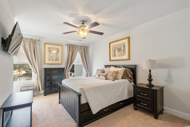 bedroom with light carpet and ceiling fan