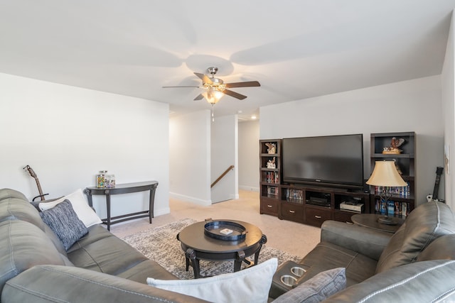 carpeted living room with ceiling fan