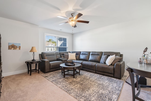 carpeted living room with ceiling fan