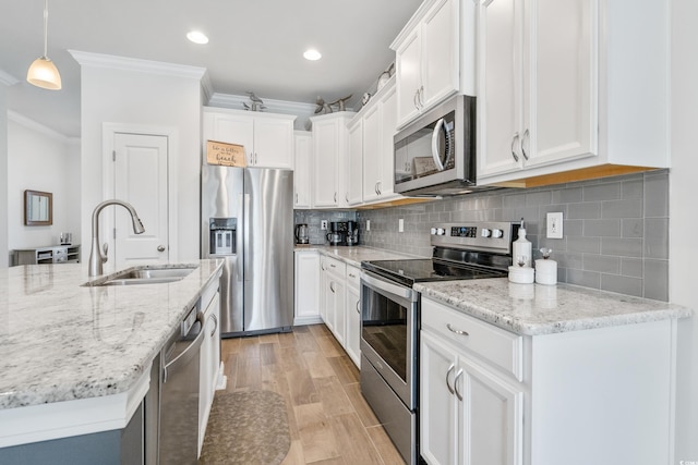 kitchen featuring sink, stainless steel appliances, and white cabinets