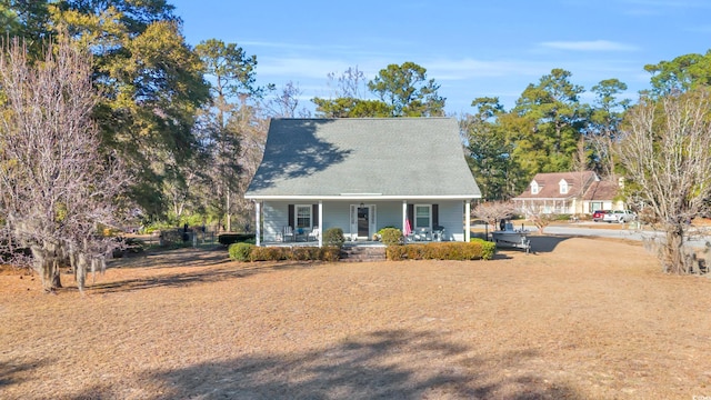 cape cod house featuring covered porch