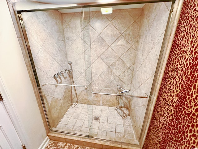 bathroom featuring a shower with door